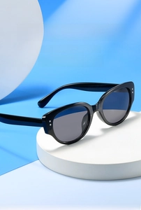 Macro detail of retro round sunglasses with black frames and silver metal stud accents