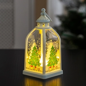 Close-up of a white Christmas lantern with warm LED light and festive tree illustration