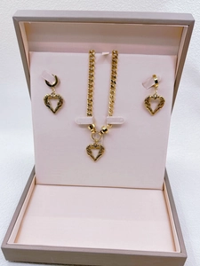 Three-piece gold stainless steel jewelry set with winged heart charms in a pink gift box