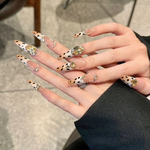 Handmade stiletto press-on nails with leopard French tips and luxury rhinestones