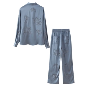 Detail of light blue satin pajamas with exquisite sequin floral embroidery and shiny beads