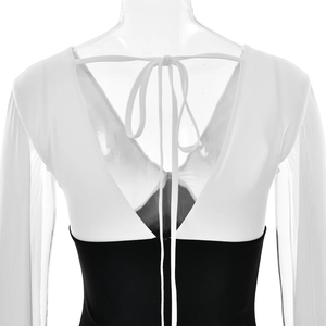 Detailed back view of a black and white bodycon dress featuring a deep V-shaped back tie