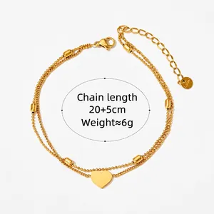 Double-layer stainless steel heart anklet with golden beads on a white background