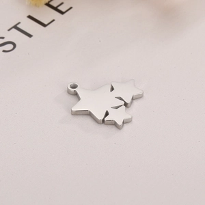 Macro detail of a silver stainless steel triple star pendant with a smooth polished finish