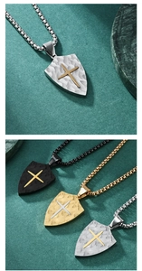 Detailed macro view of shield cross pendants with textured bark finish in various metal tones