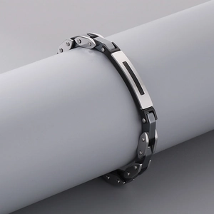 Detailed macro view of industrial mechanical link bracelet in silver and black stainless steel