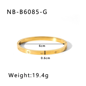 Detail view of gold eight-pointed star engraved bangle with rhinestones and 6cm diameter