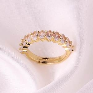 Adjustable gold plated ring featuring oval cut colorful zircon stones on white silk