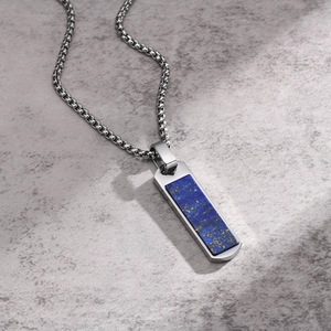 Detail of silver rectangle pendant featuring natural blue lapis lazuli stone inlay