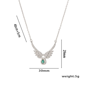 Silver angel wing necklace with green teardrop stone and zircon accents on white background