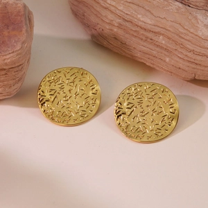 Macro detail of gold vintage geometric round stud earrings with pleated metal texture