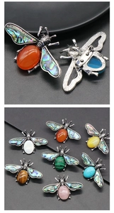 Detailed front and back view of crystal bee brooches with colorful stone inlay