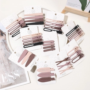 Close-up of matte brown and pink hair clips set on a handmade display card