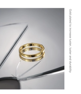 Detail of gold plated ring on reflective mirror surfaces with clear reflections