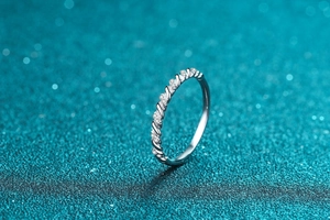 Macro detail of S925 sterling silver twisted ring with shimmering moissanite stones