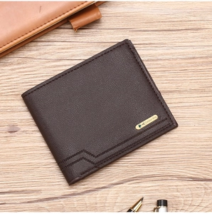 Detailed close-up of brown litchi grain leather wallet with a metal logo on a wooden desk