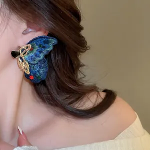 Asymmetric blue embroidered butterfly stud earrings with colorful crystals and gold metal