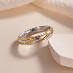 Polished stainless steel couple ring with gold-tone diagonal grooves and set diamonds
