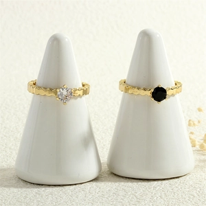 Detail of 18K gold plated wavy rings with inlaid black and white zircon stones