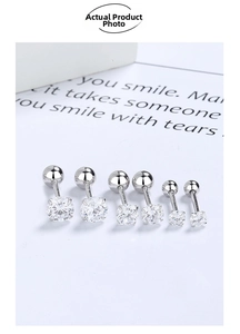 Detailed macro view of three pairs of four-claw zircon stud earrings with screw ball backs