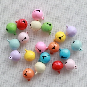 Mix of 14mm colorful metal round bells for DIY crafts and pet accessories on woven fabric