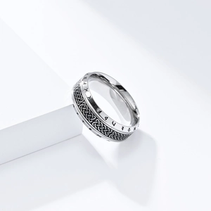 Close-up of Viking runes and Celtic knot embossing on a vintage steel ring