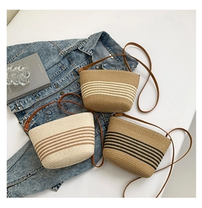 Detailed overhead view of striped straw crossbody bags in cream, tan, and brown tones