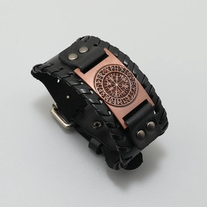 Detail of Viking Vegvisir compass charm on braided black leather bracelet with rivets
