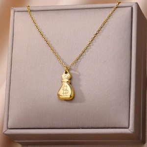 Detailed shot of a gold money bag pendant with dollar sign on a vintage chain