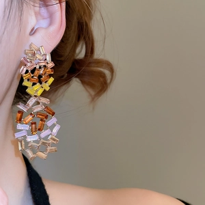 Detail of dangling colorful crystal drop earrings with rectangular cut stones