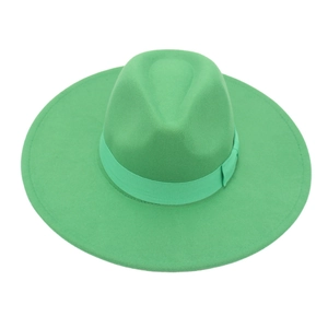 Detailed view of wide-brimmed grass green wool fedora hat with matching ribbon bow