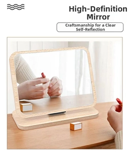 Detail of a rectangular wooden desktop makeup mirror with a sturdy base on a desk