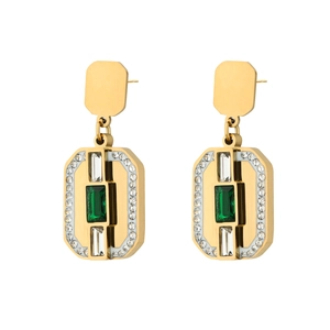 Detailed macro view of gold snake-style rectangle earrings with emerald green crystals