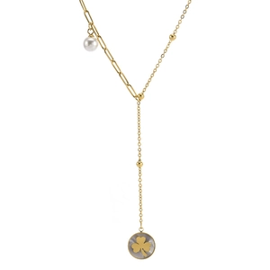 Golden Y-necklace with pearls and clover pendant featuring white shell inlay on white background