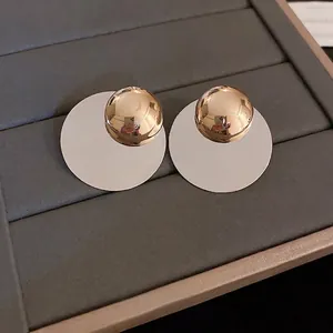 Minimalist silver circular disk earrings with polished gold sphere stud accents