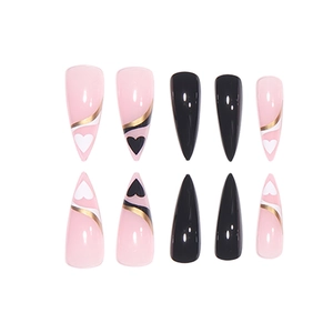 Pink and black long stiletto press-on nails with gold lines and heart patterns