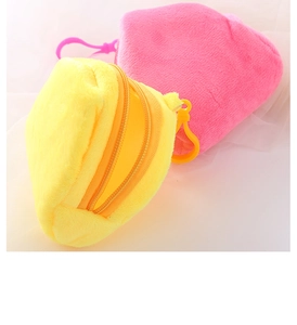 Close-up of pink and yellow plush coin purses with zippers and plastic hooks