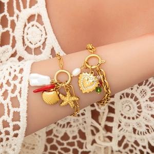 18K gold plated charm bracelet featuring baroque pearls, sea stars and heart pendants