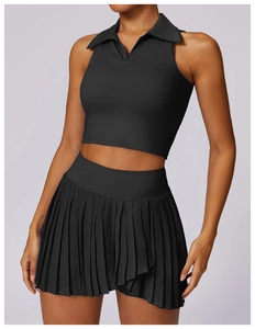 Detail of black sleeveless polo top and high waisted pleated skirt for sports