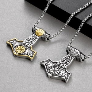 Close-up of Viking Mjolnir pendant with double wolf heads in silver and two-tone finishes