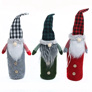 Three Nordic forest gnome wine bottle covers in red, green and grey plaid for Christmas decor