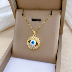 Macro detail of gold Evil Eye pendant with pavé cubic zirconia in a jewelry gift box