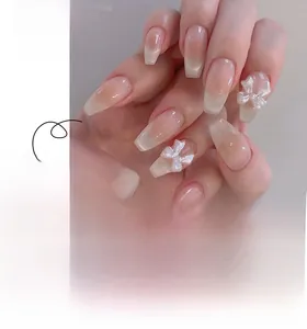 Detail of sweet blush cat-eye nails with 3D bows and gradient pink ballet shape