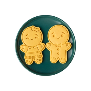 Japanese gingerbread man cookie molds set for Christmas baking on a green plate