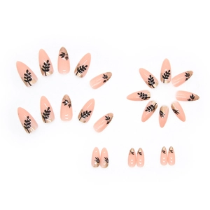 Almond press-on nails with nude base, black leaf patterns and gold foil gradient details