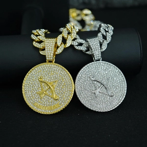 Detail of gold and silver Sagittarius zodiac pendants with rhinestones on Cuban chains