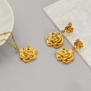 Detail view of 18K gold plated stainless steel rose necklace and earrings set