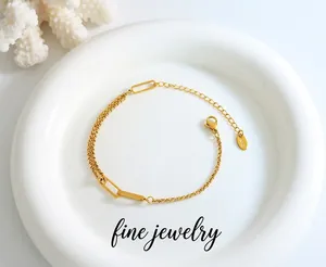 Close-up of golden stainless steel chain bracelet with K18 tag and adjustable lobster clasp