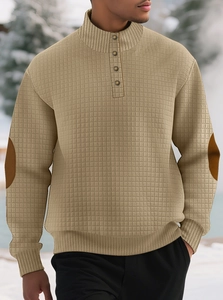 Detail of khaki waffle knit texture with buttons and elbow patches on men's pullover