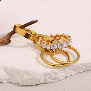 Macro detail of 18K gold plated multi-layer rings with zircons on stone base